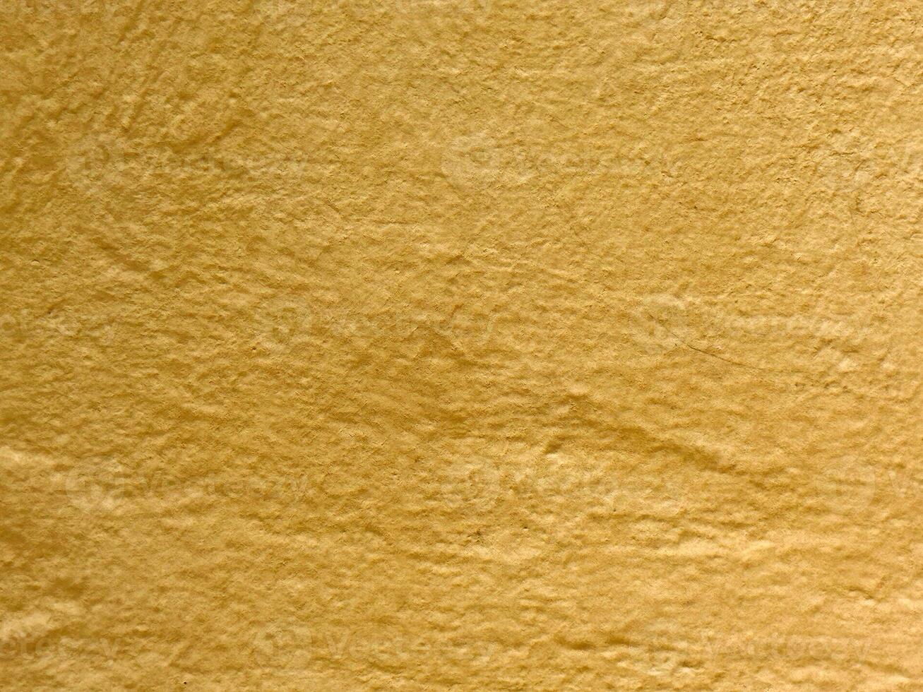 Textured yellow paper surface with natural wrinkles and folds photo