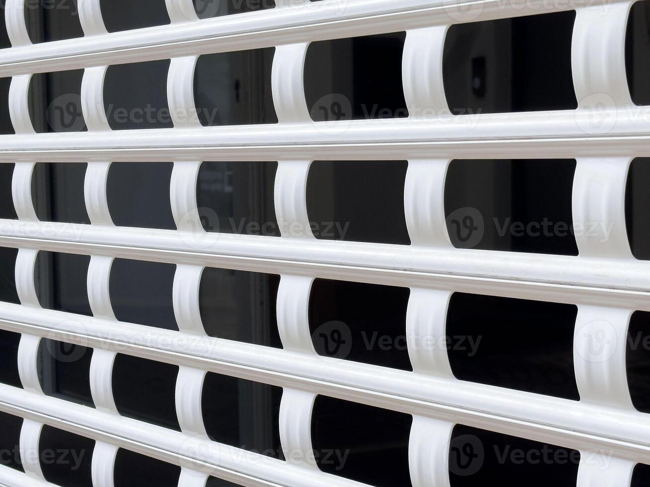 White metal grid pattern on a building window for security and design photo