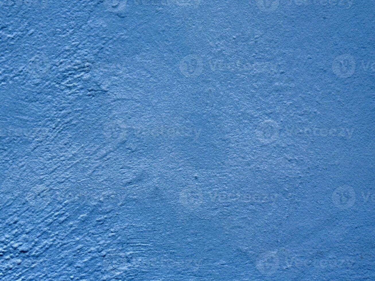Textured blue wall surface with rough pattern background photo