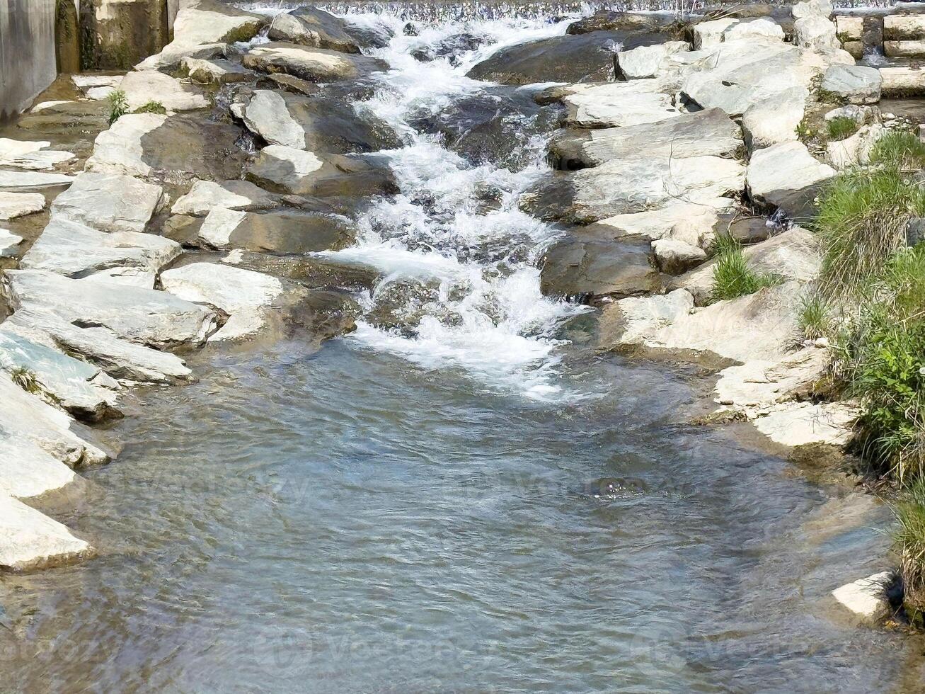 Clear rocky stream with flowing water in natural setting photo