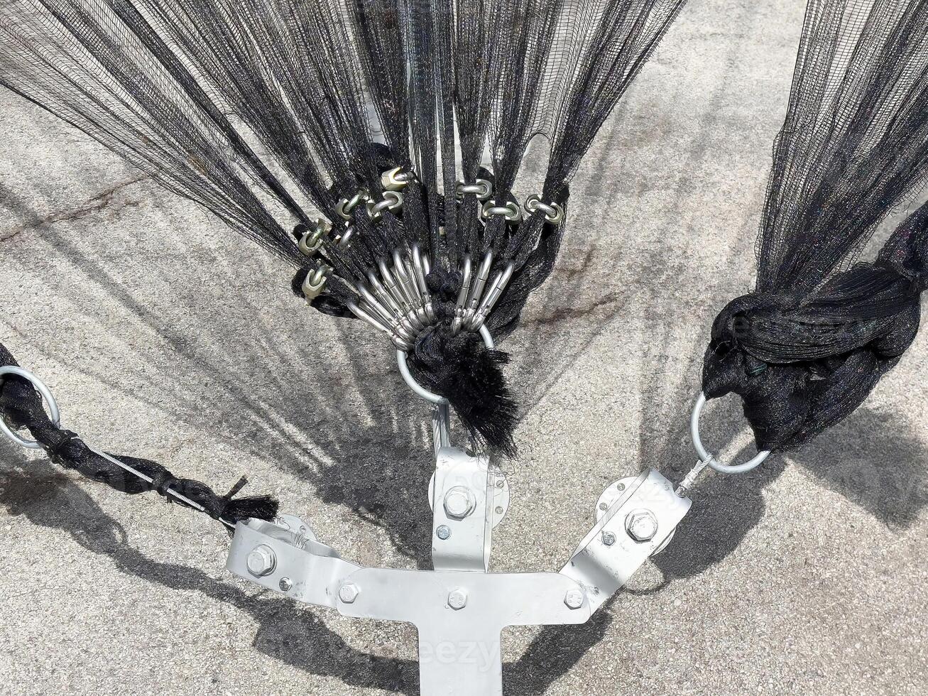 Close-up of parachute suspension lines and risers on concrete surface photo