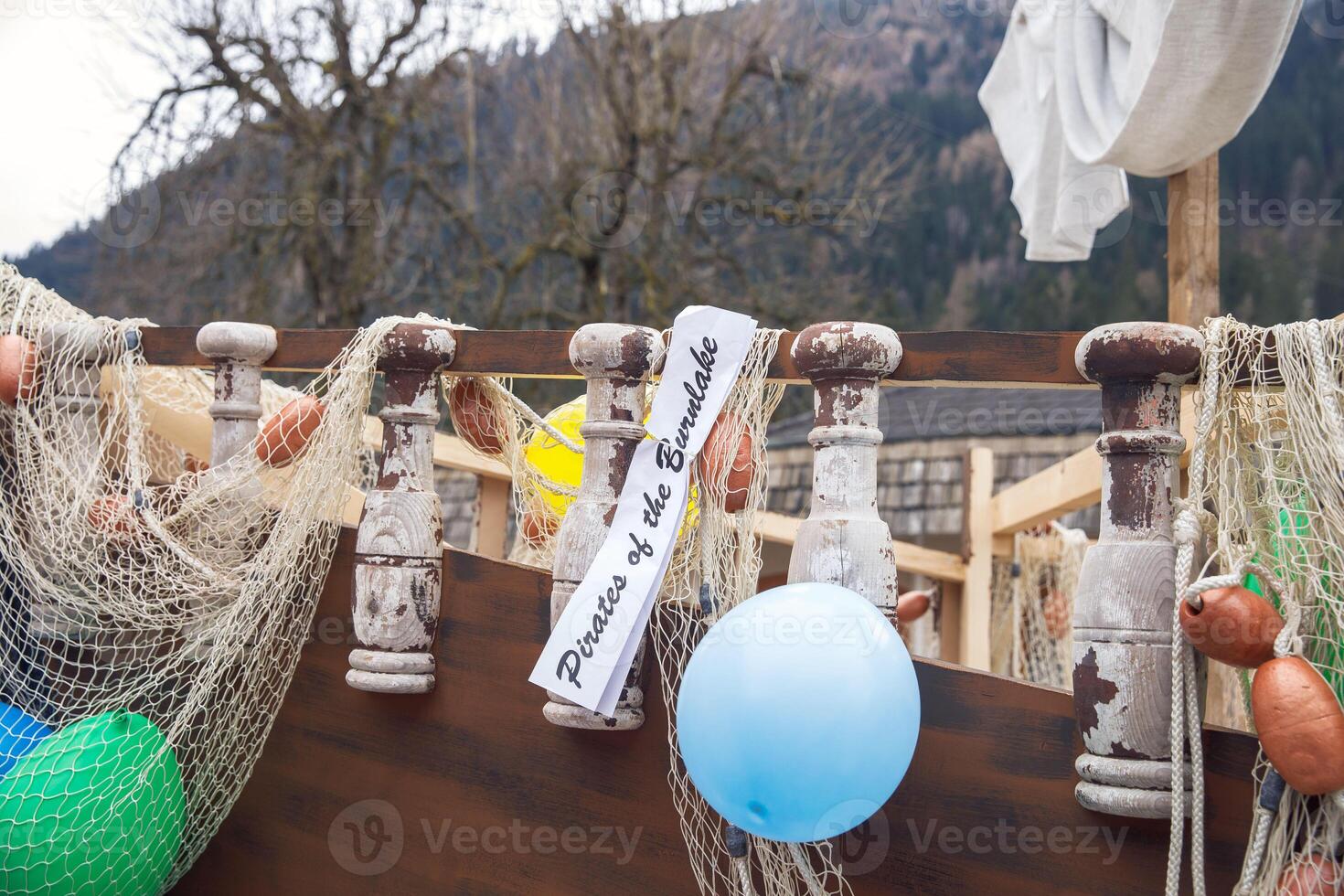 Decorative pirate ship with nets and balloons at outdoor event photo