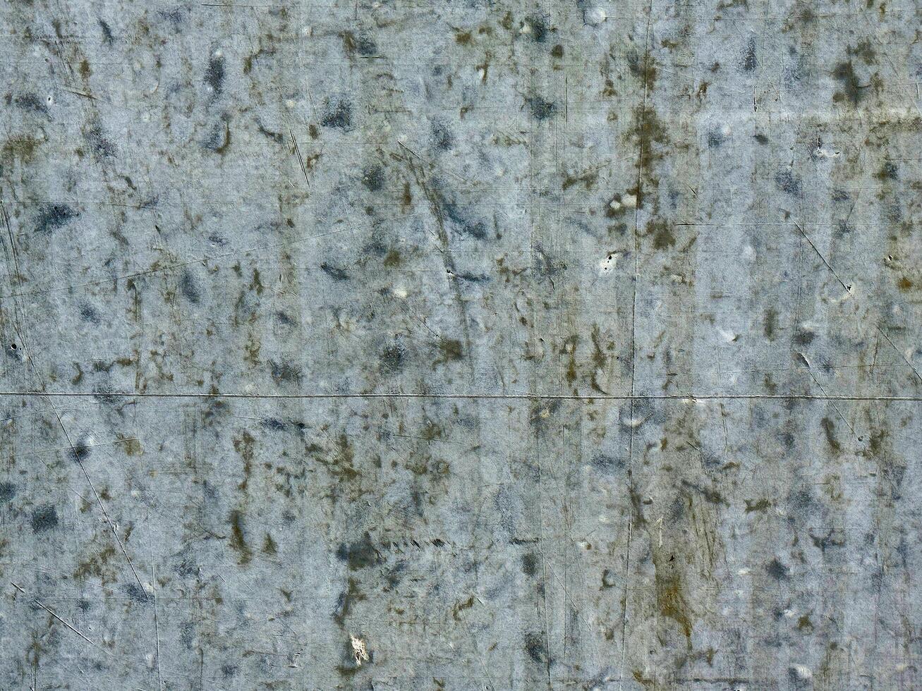 Close-up of textured gray cement wall surface with weathered patterns photo