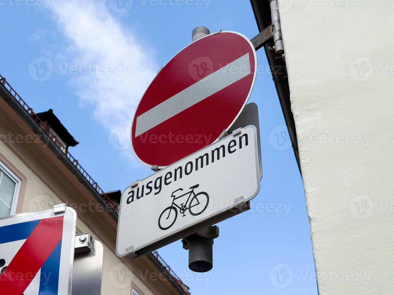No entry sign with bicycle exception on urban street photo