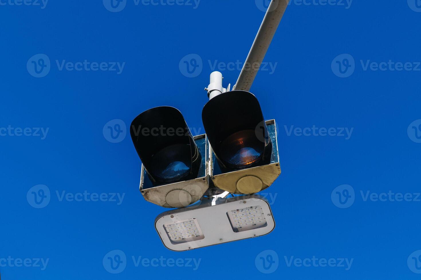 Traffic light against clear blue sky on a sunny day photo