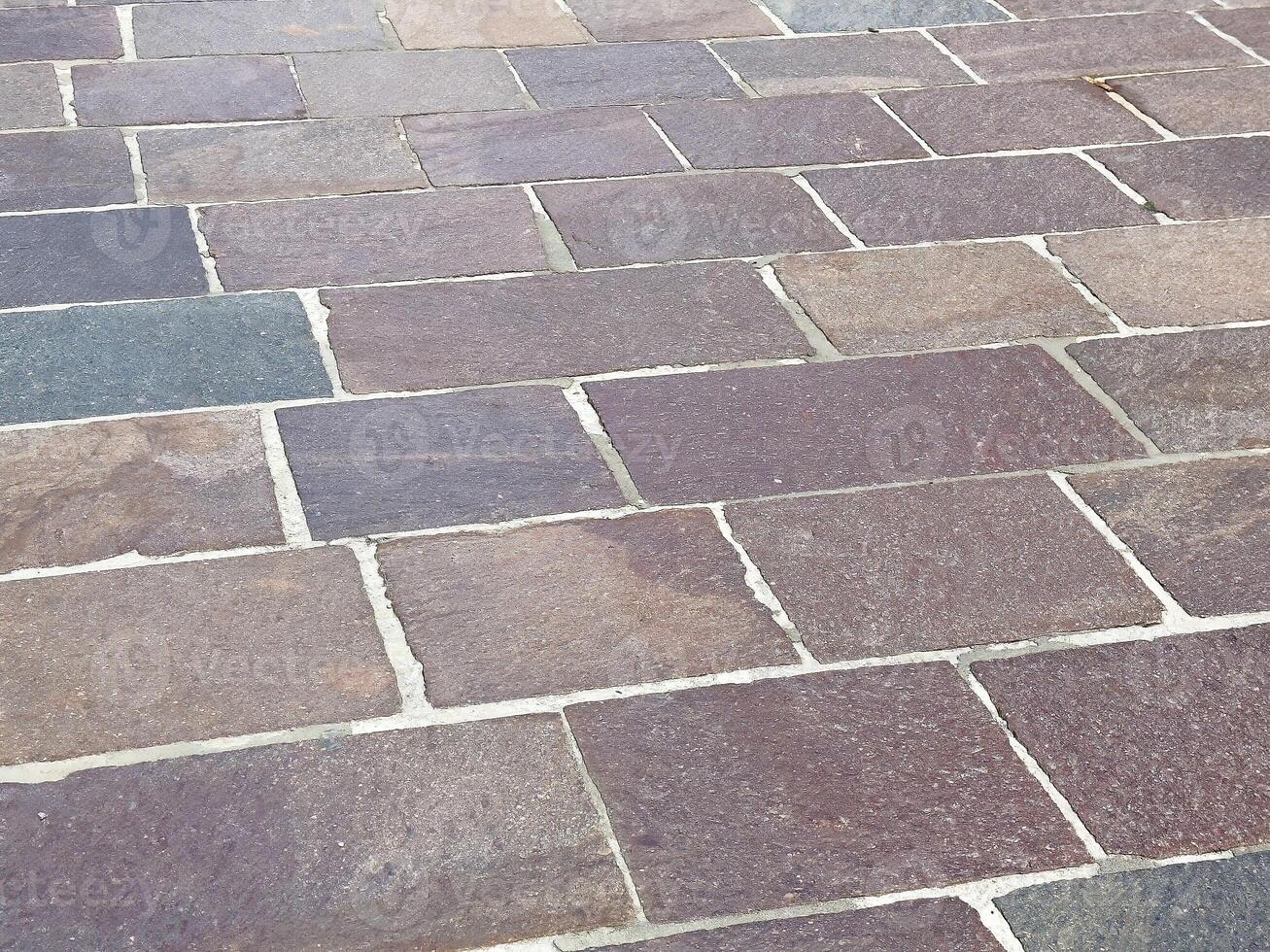 Close-up of varied color stone brick pavement with irregular patterns photo