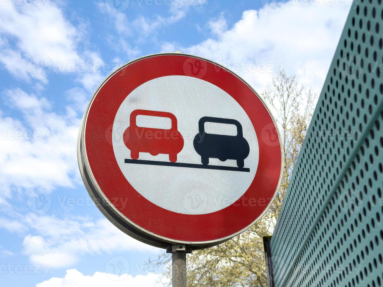 Road sign indicating no overtaking zone with two cars symbol photo