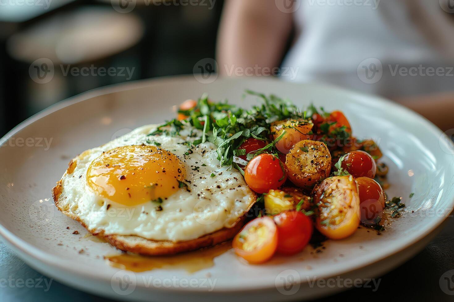 A plate with an egg, tomatoes and herbs on it photo