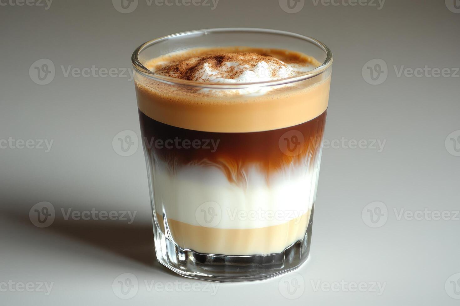 An espresso drink with a white and brown topping photo
