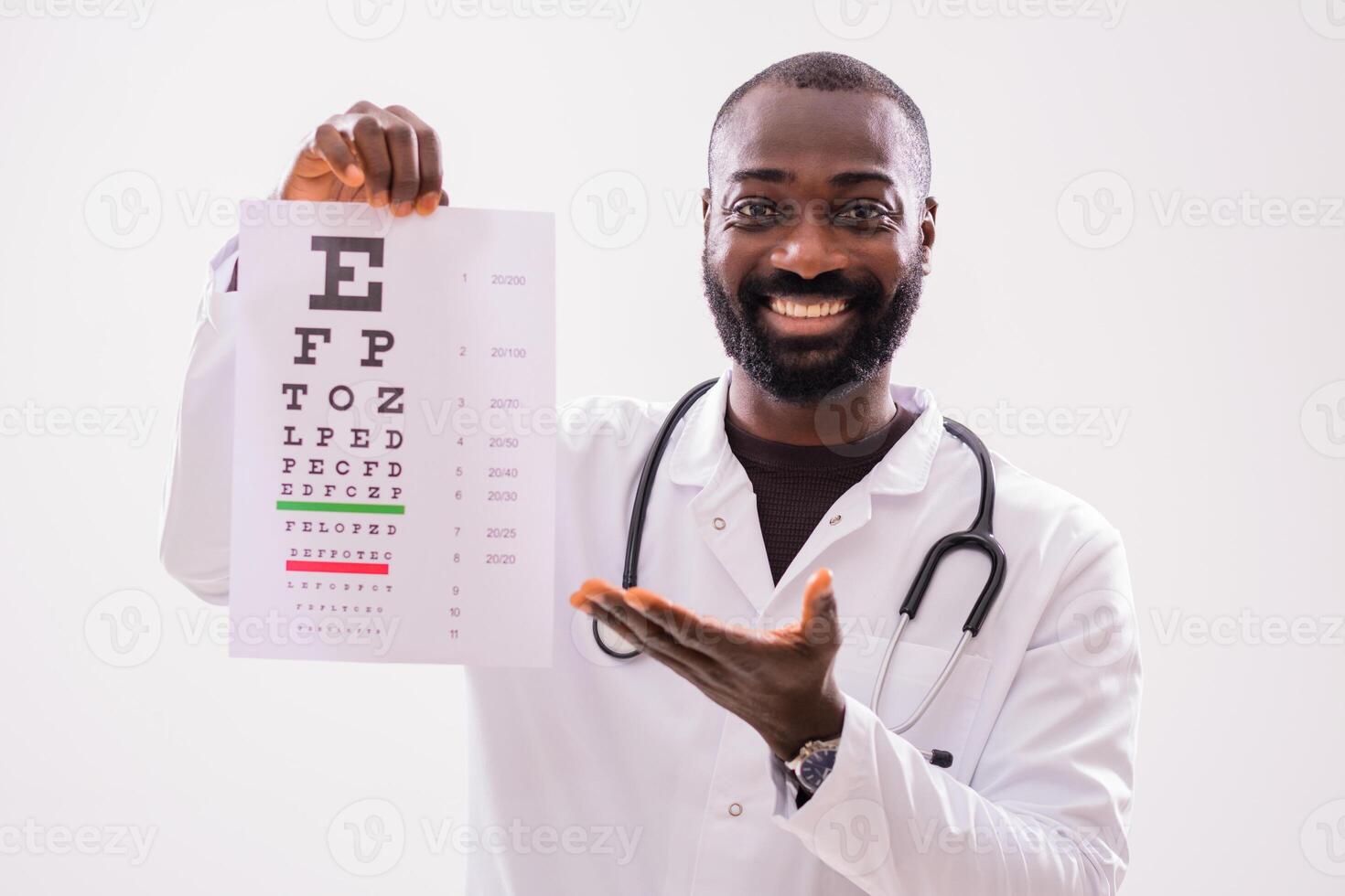 Portrait of smiling African American doctor who is showing eye examination test. photo
