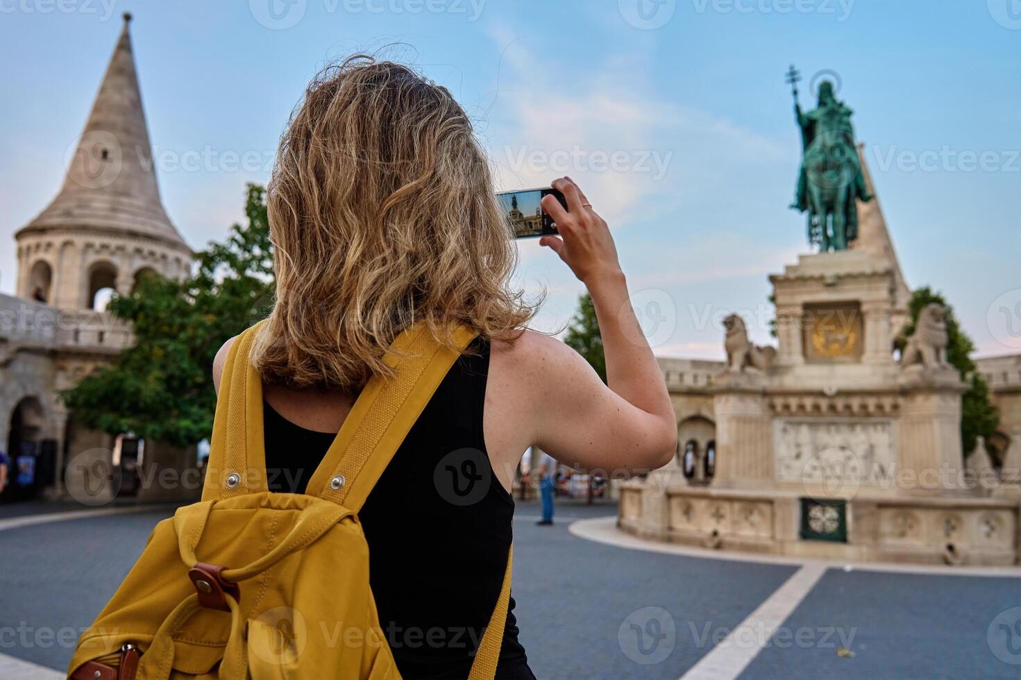Tourist photographing historic landmark with smartphone photo