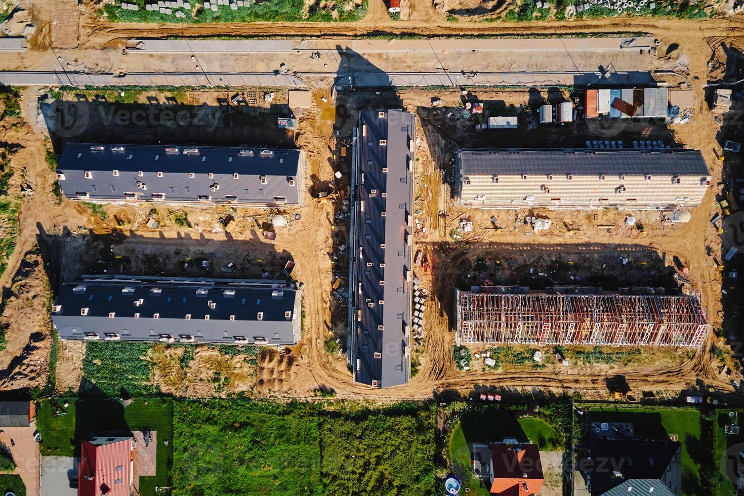 Aerial view of large housing estate under construction with modern residential buildings in small town. Suburban neighborhood photo