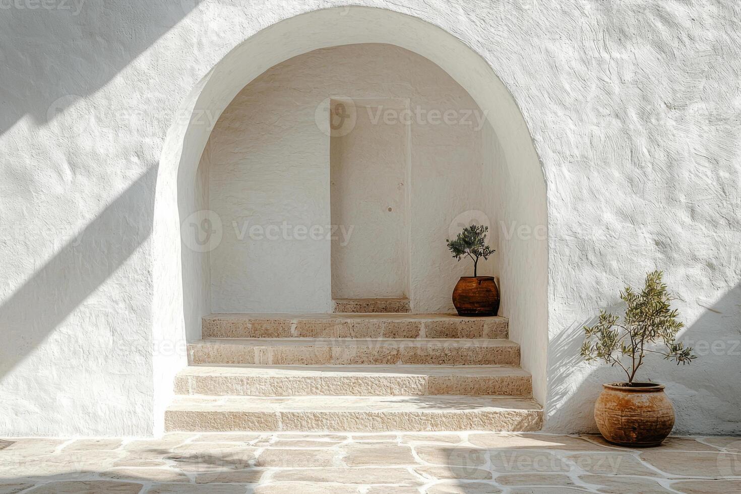 White arched doorway with terracotta pots and stairs photo