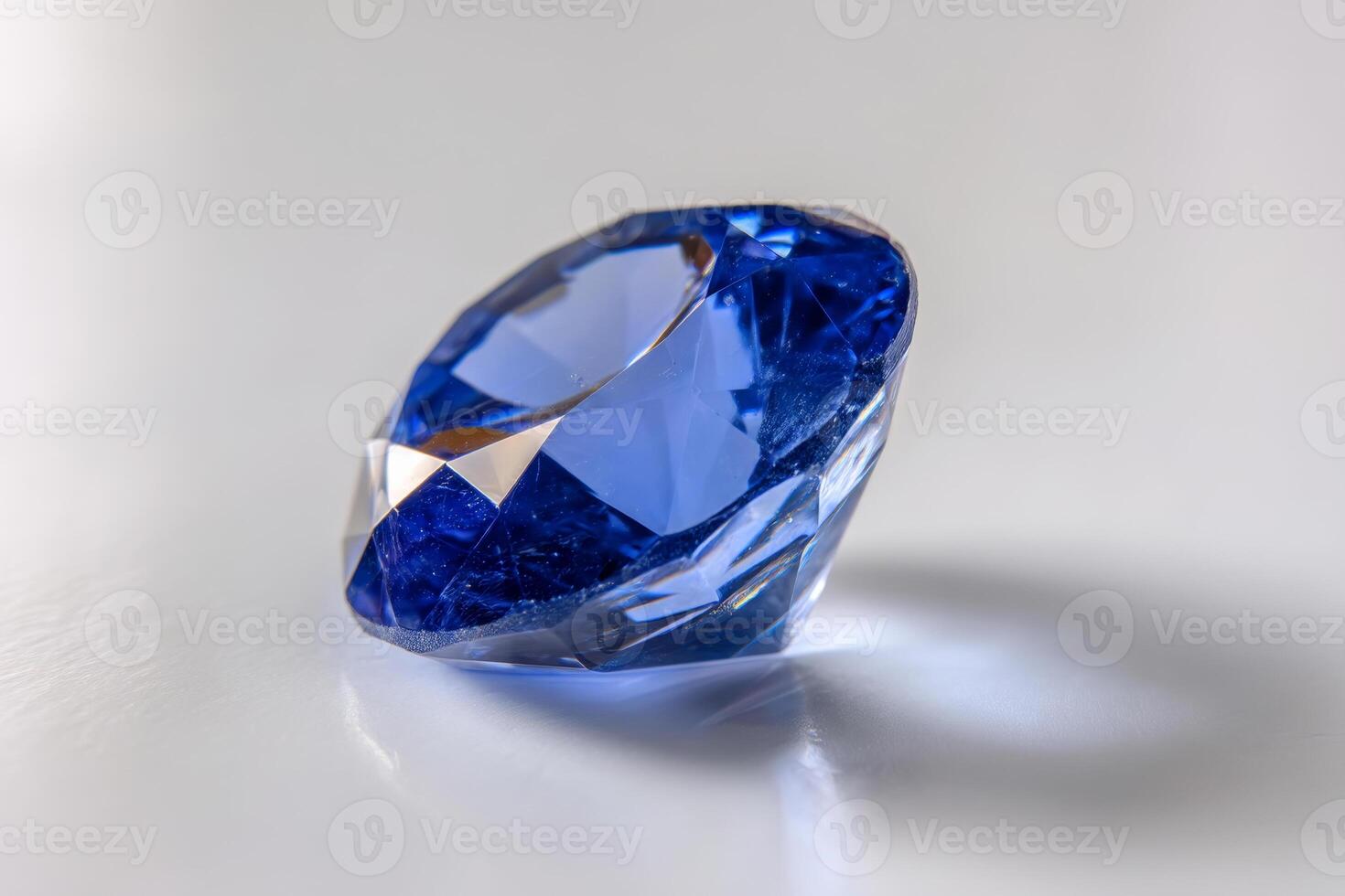 Brilliant blue sapphire on white background. Faceted gemstone, close up photo