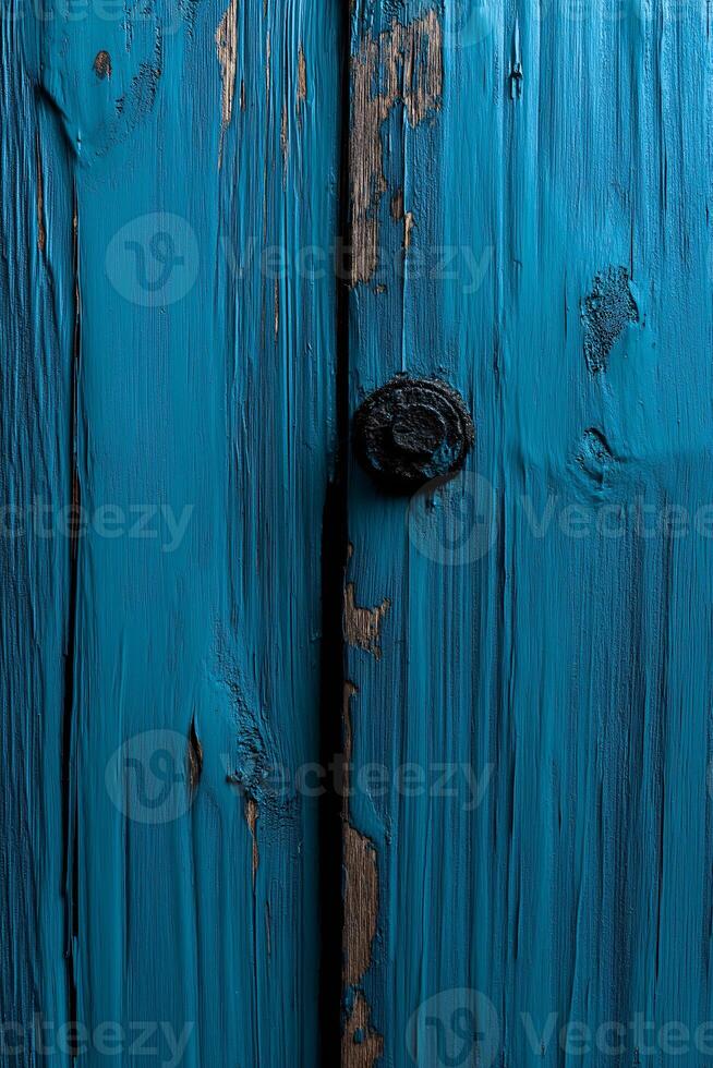 A blue painted wooden door with a wooden handle photo