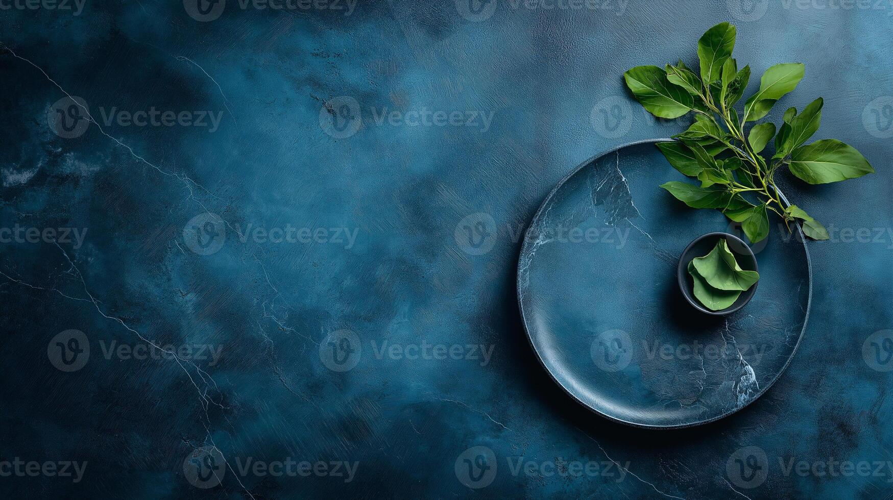 A blue marble table with a green leaf on it photo