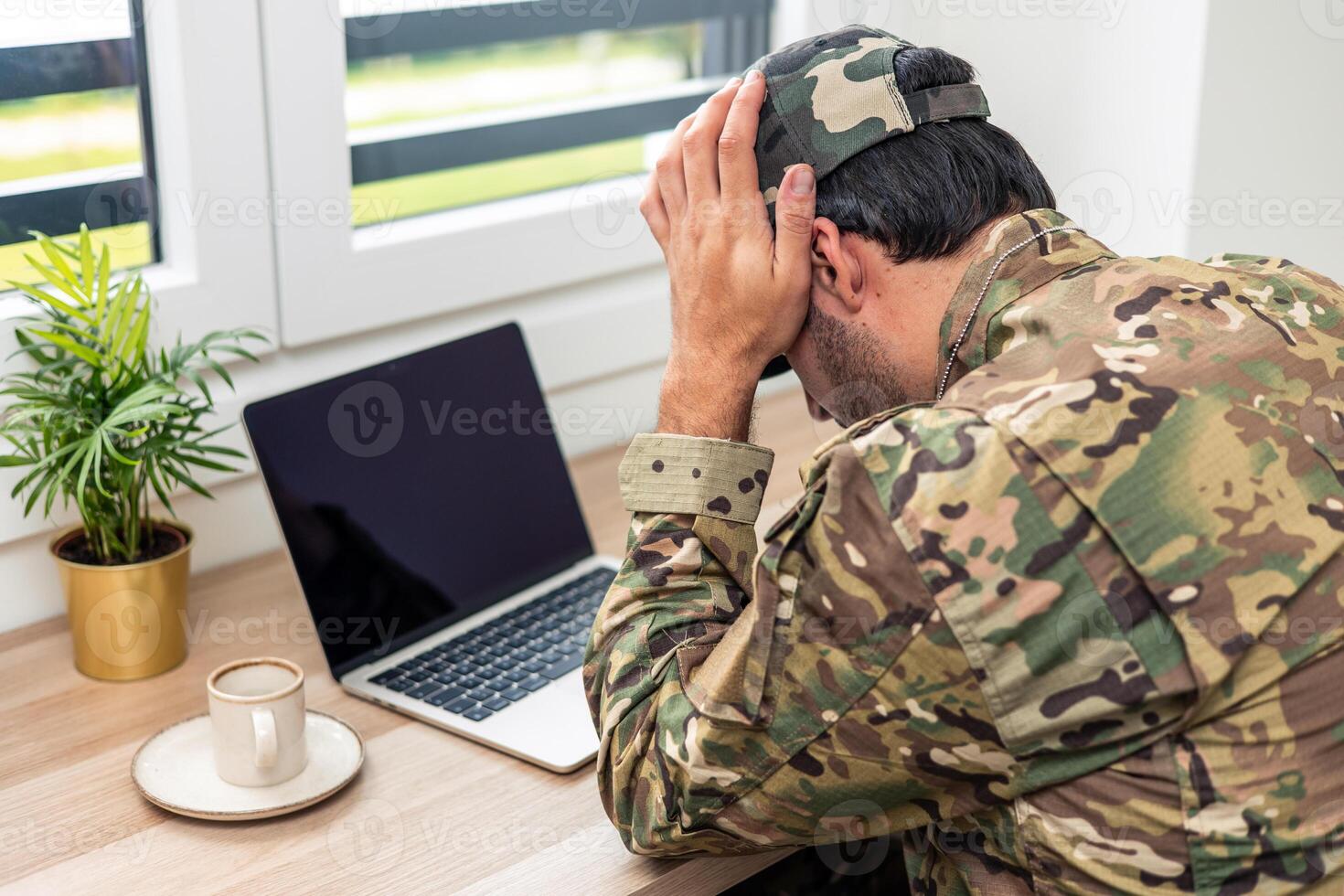 Stressed soldier suffering from ptsd having a breakdown at home photo