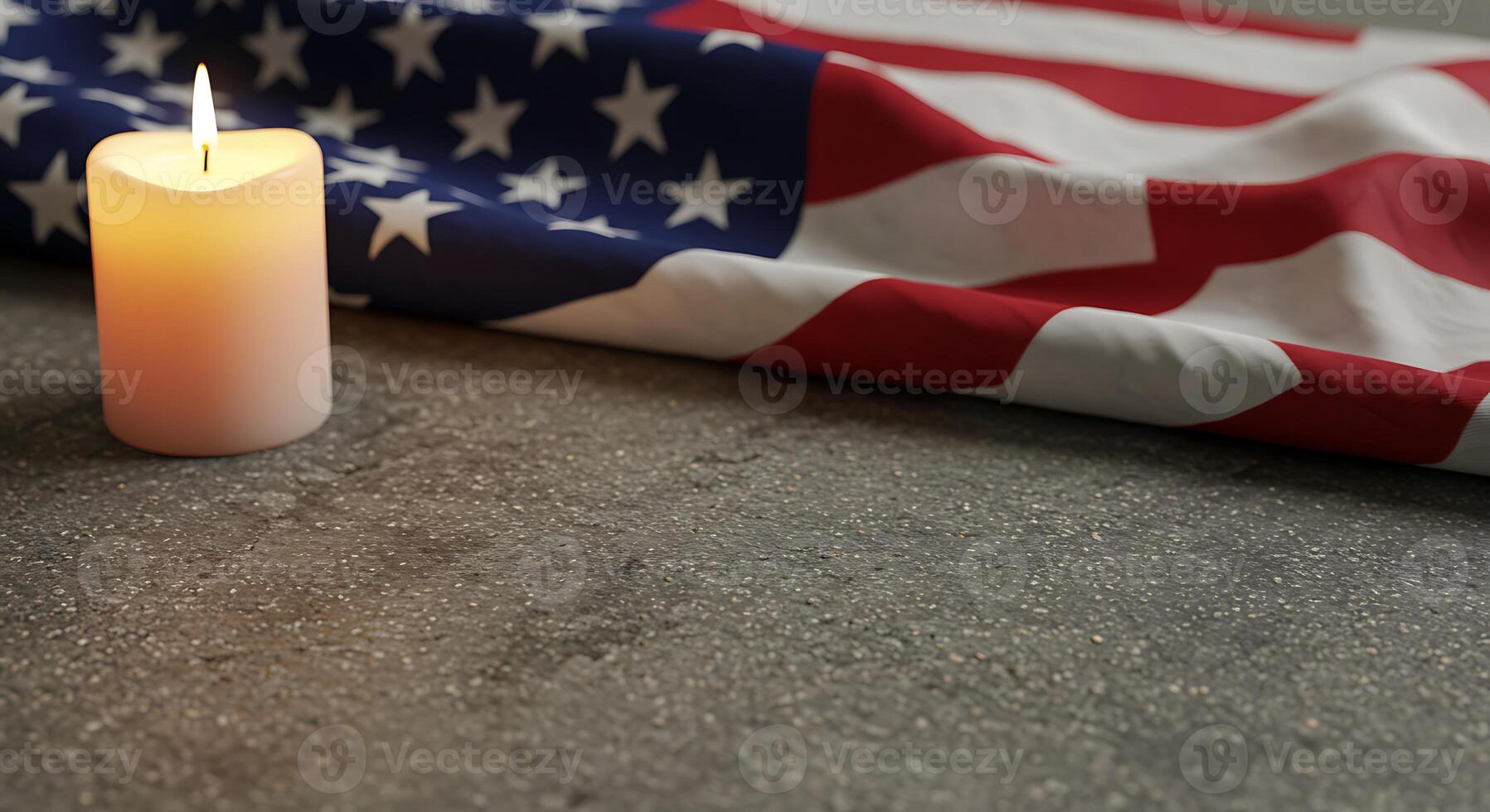 A lit candle rests beside a folded American flag, a poignant tribute symbolizing remembrance and respect. photo