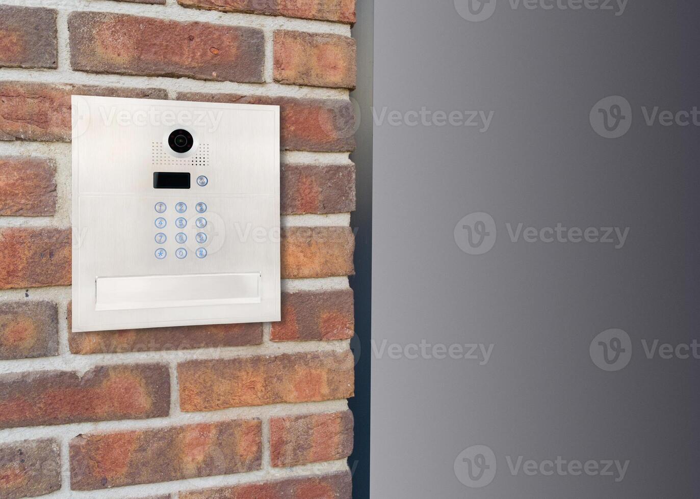 Metal Keypad Intercom on Corner Brick Wall photo