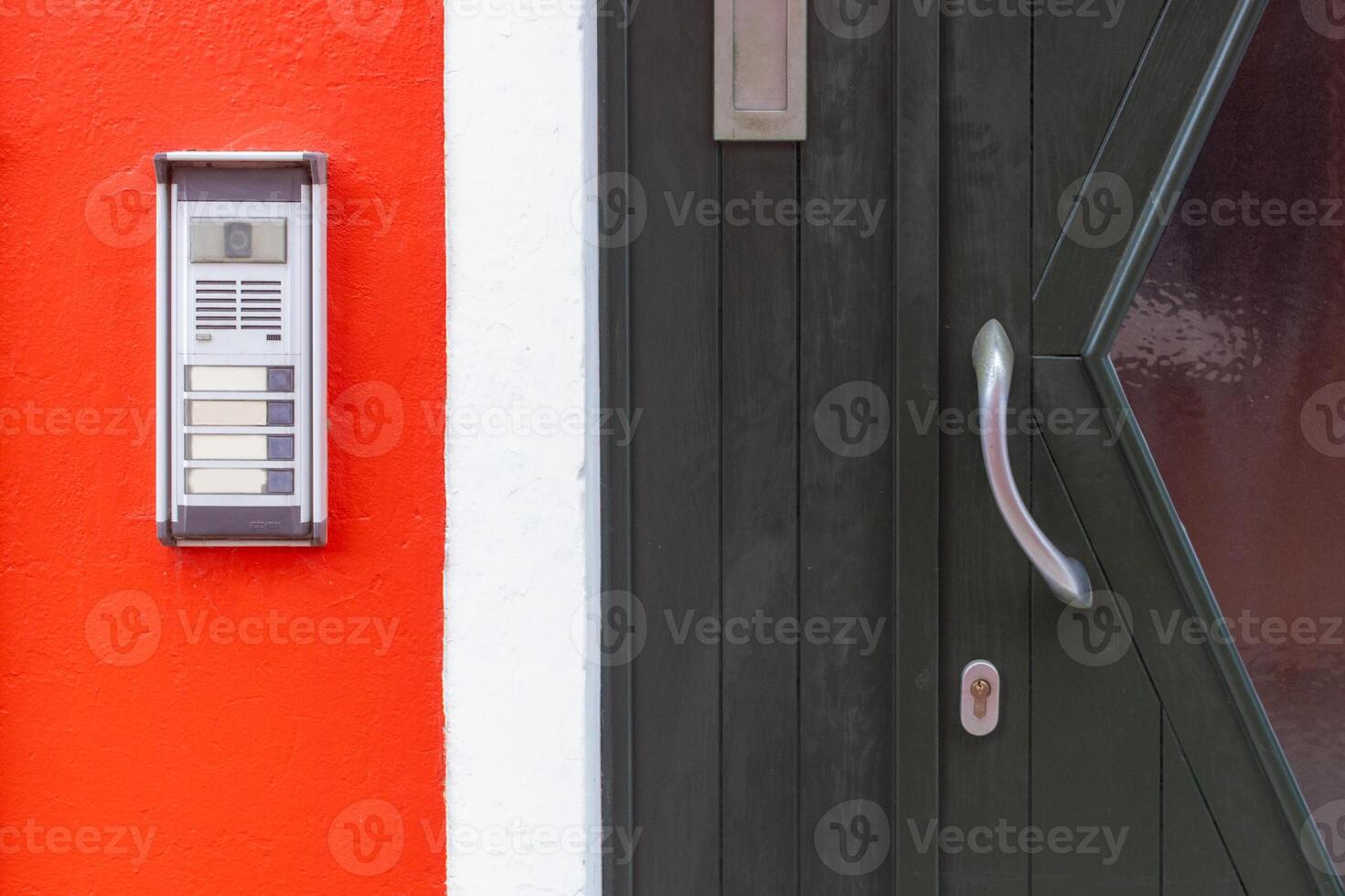 Door intercom on red wall in Burano Italy photo