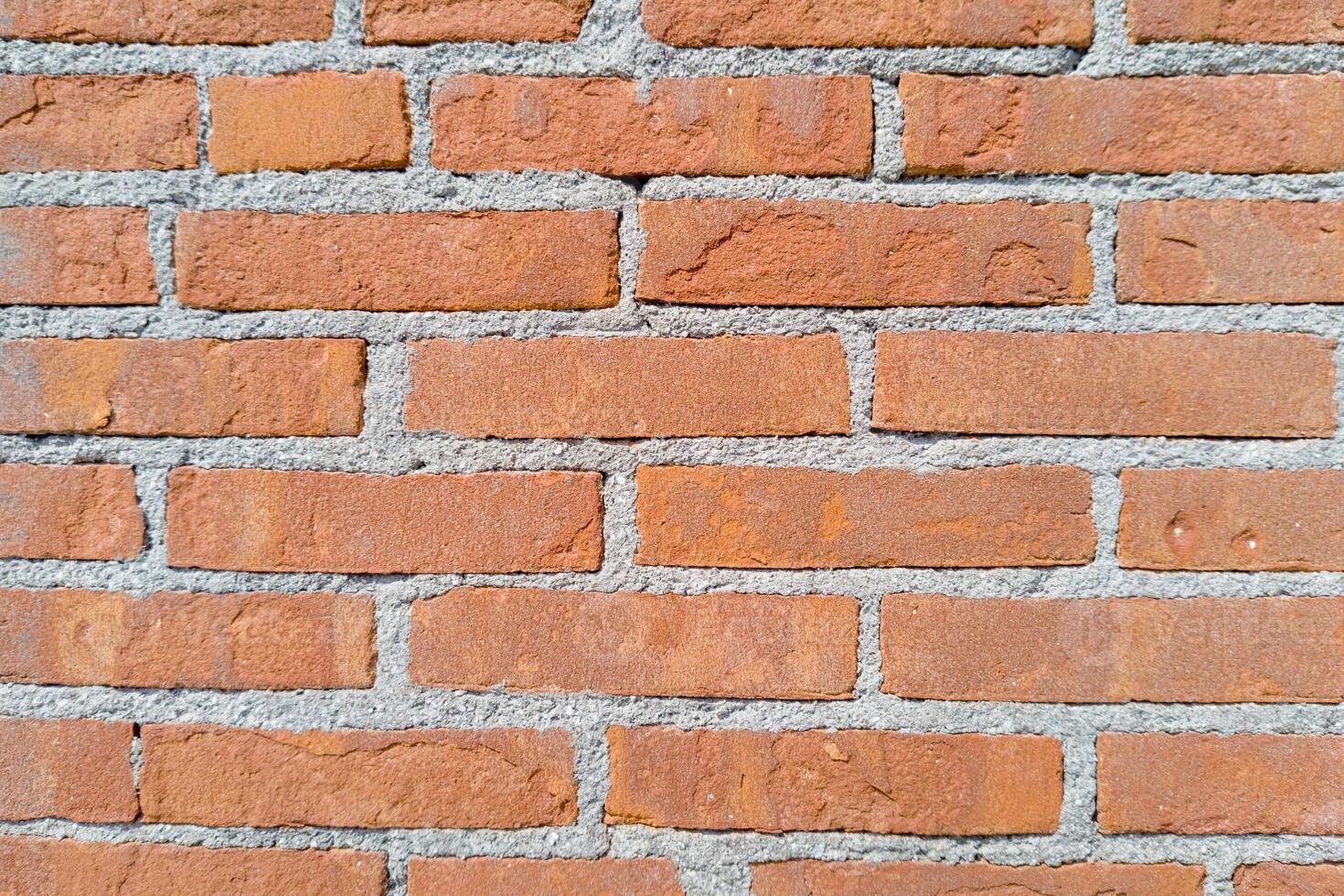 Evenly Laid Red Brick Wall with Gray Mortar photo