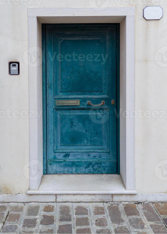 Old turquoise door with frame and intercom photo