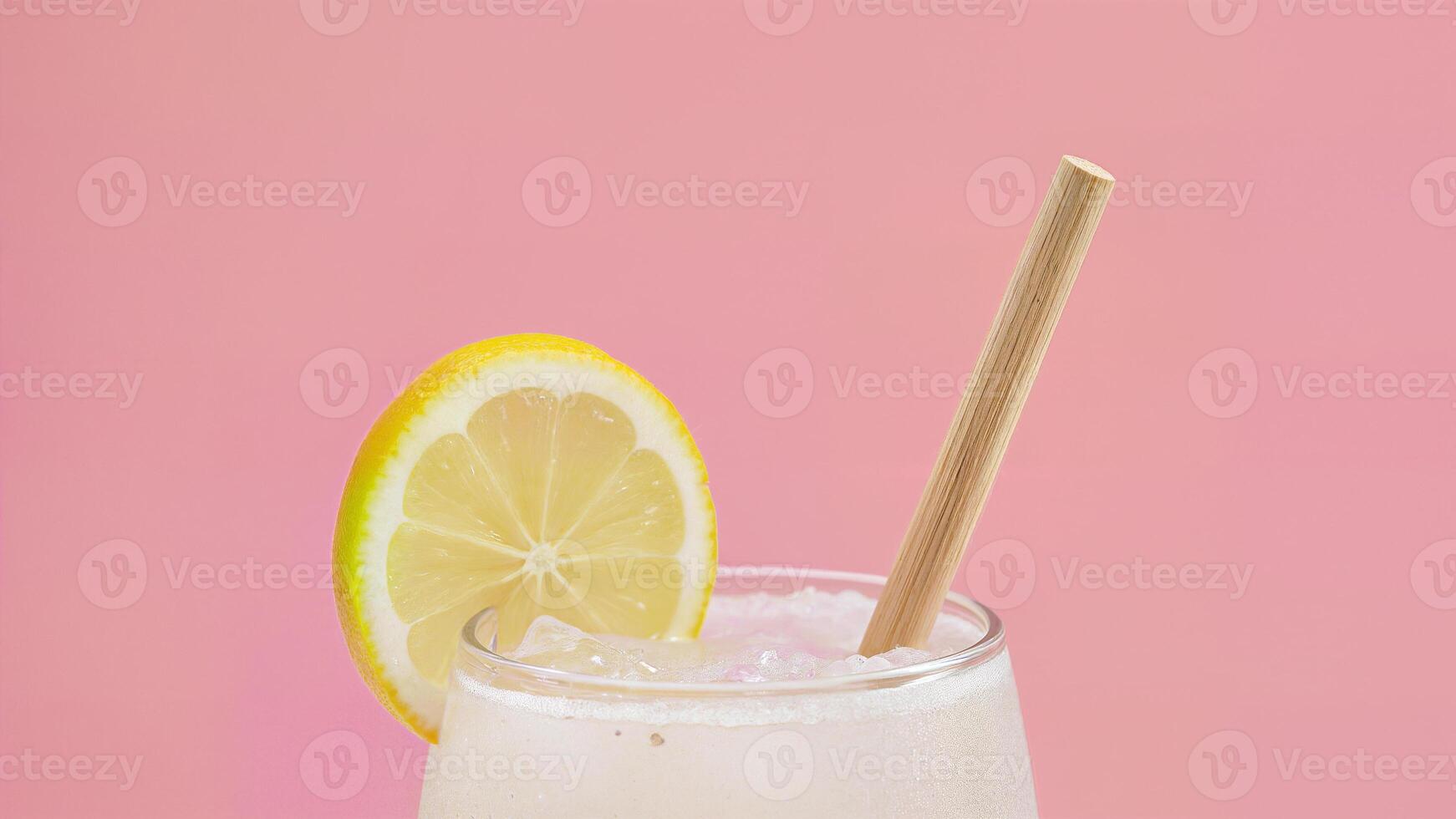Bamboo Straw in Lemon Water on Pink Background photo