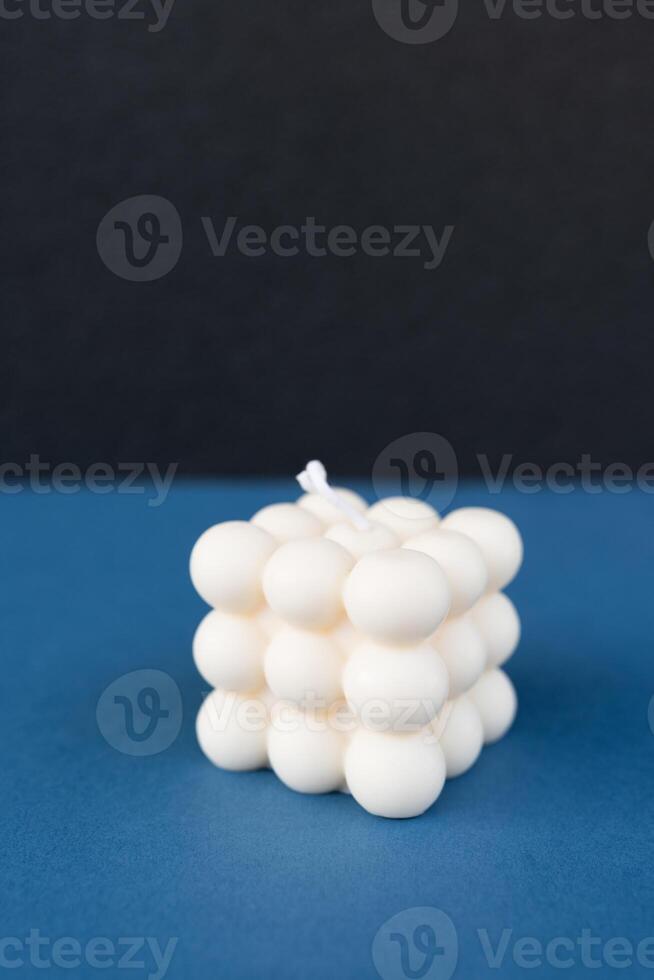 Modern Bubble Cube Candle on Blue Surface photo