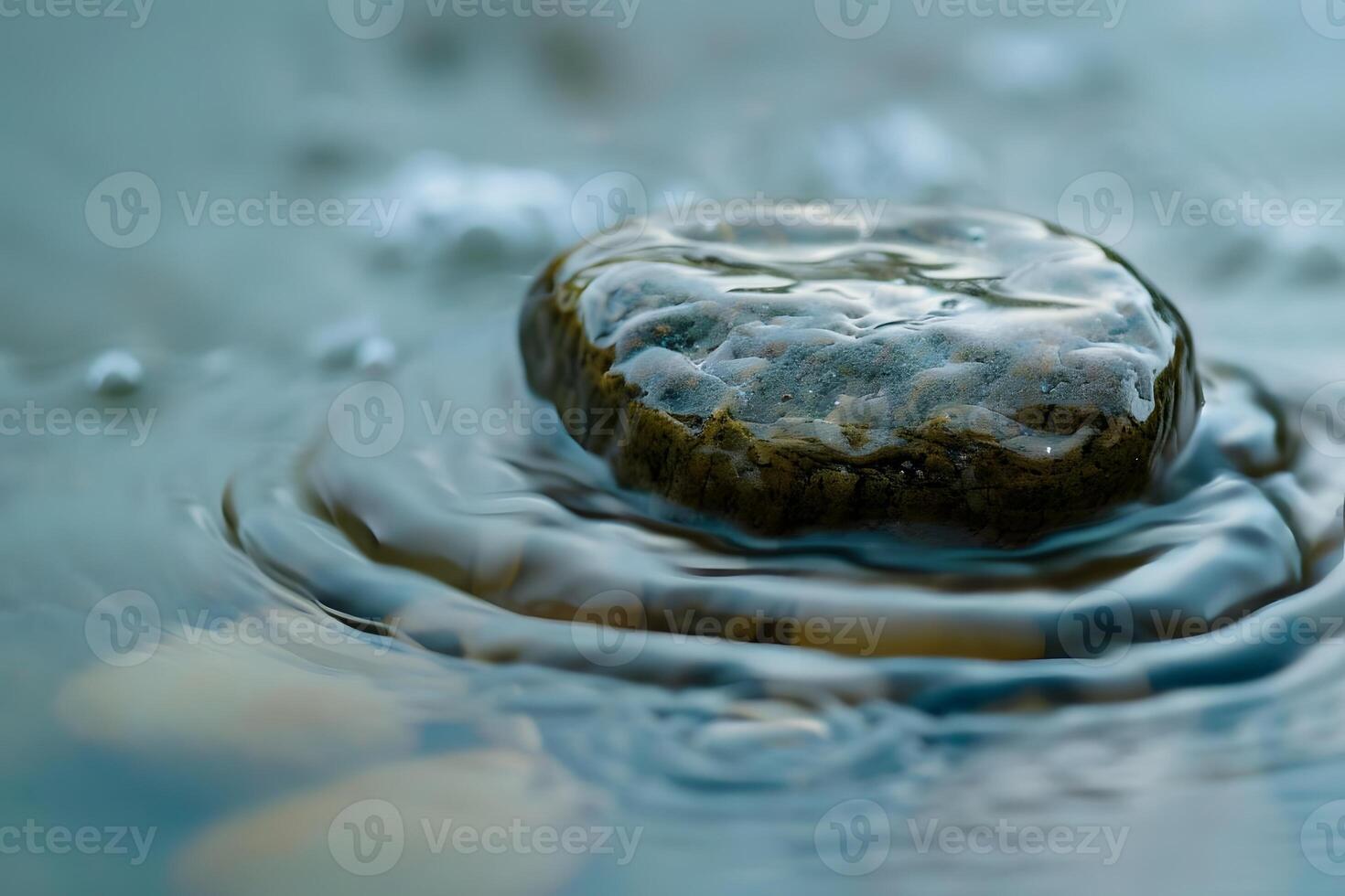 Serene Stone Submerges Gently in Water, Creating Concentric Ripples Tranquil Nature Scene with Water Texture and Flowing Stream photo