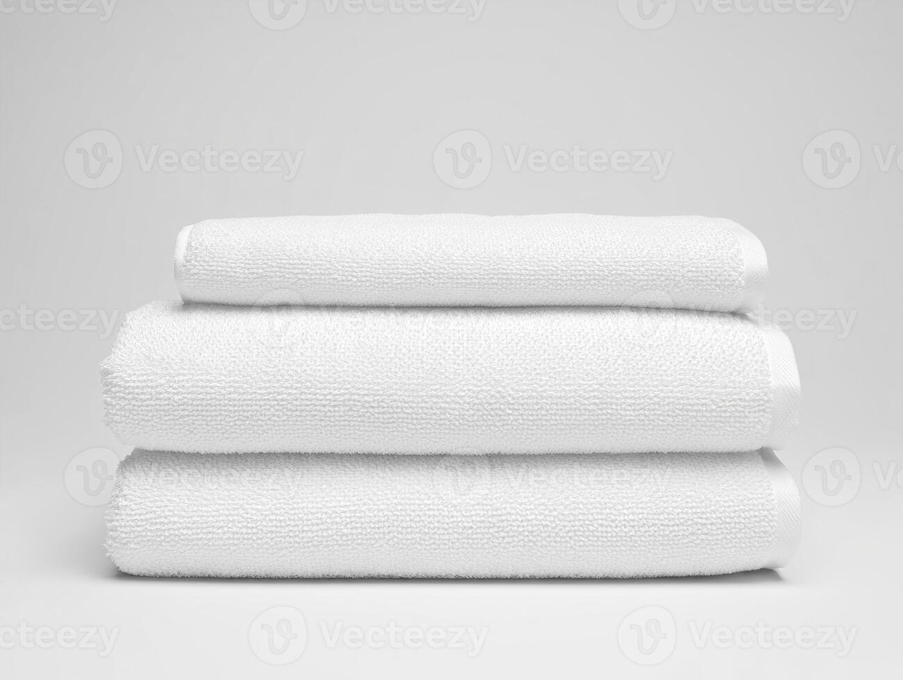 Three white towels stacked on top of each other photo