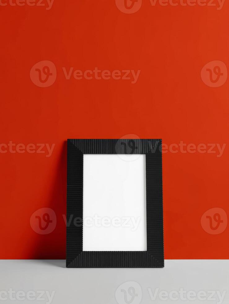 A black square frame on a red wall photo