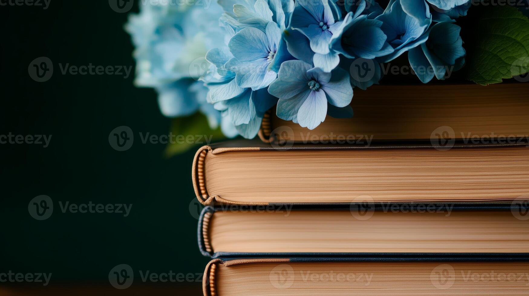 A stack of books with blue flowers sitting on top photo