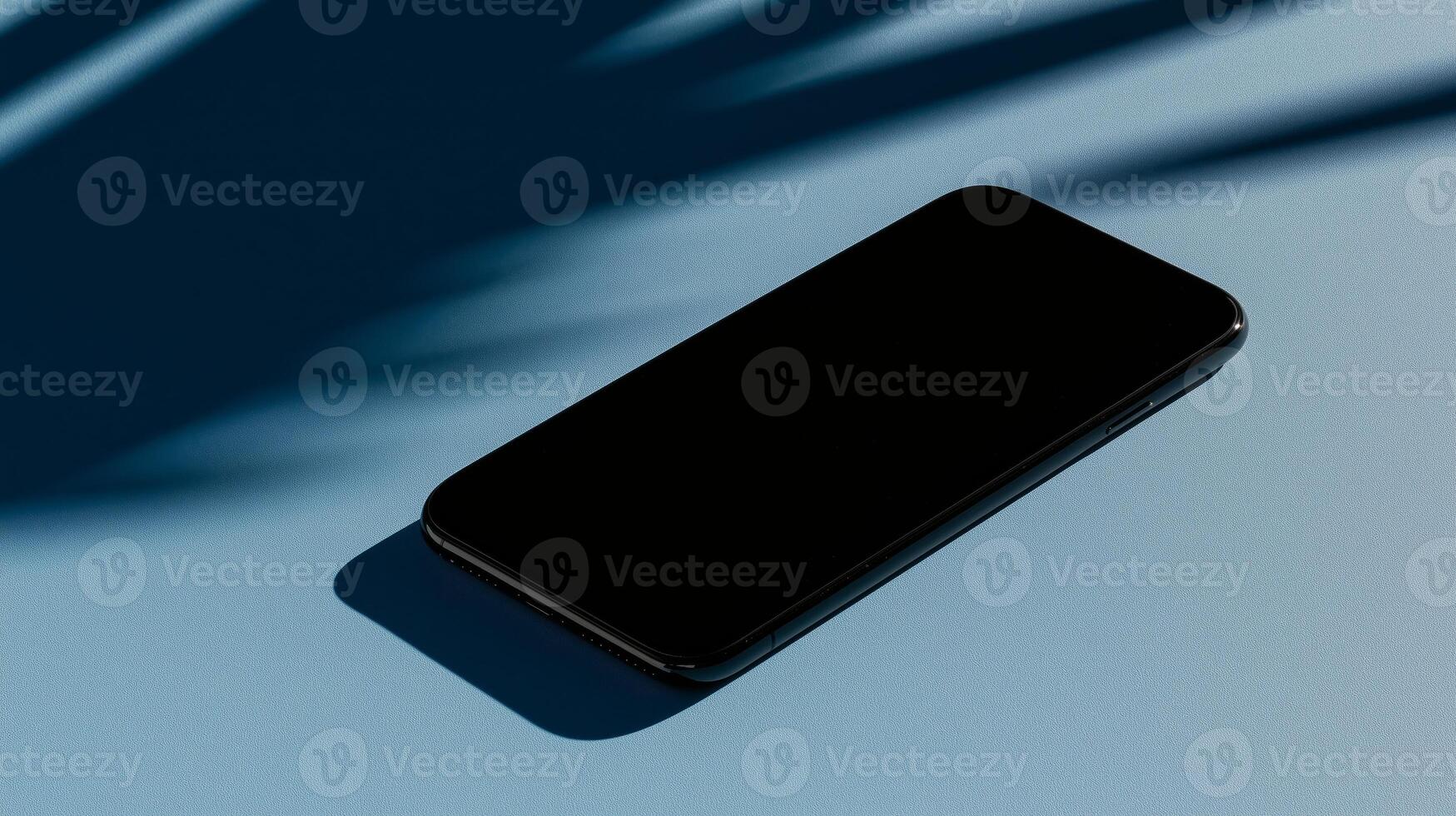 A phone rests on a smooth blue surface photo