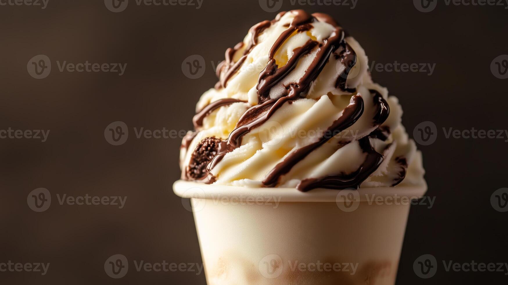 A cup of ice cream with chocolate and whipped cream photo