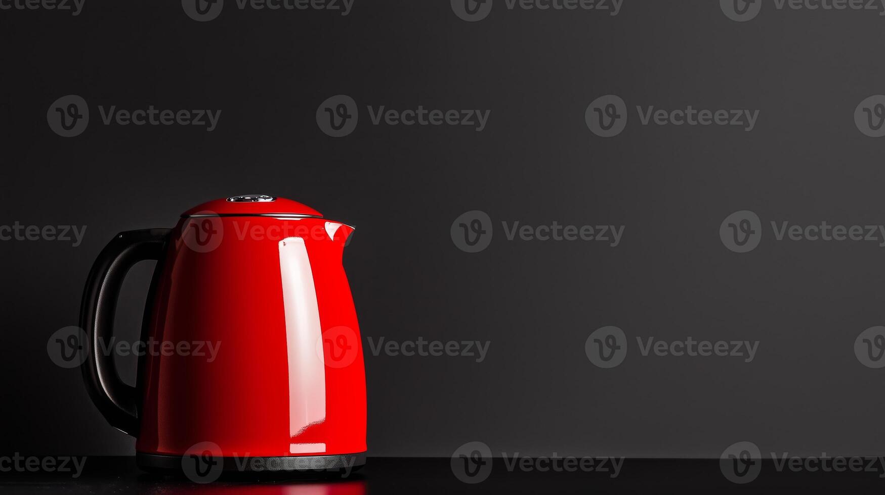 A red kettle on a black table photo