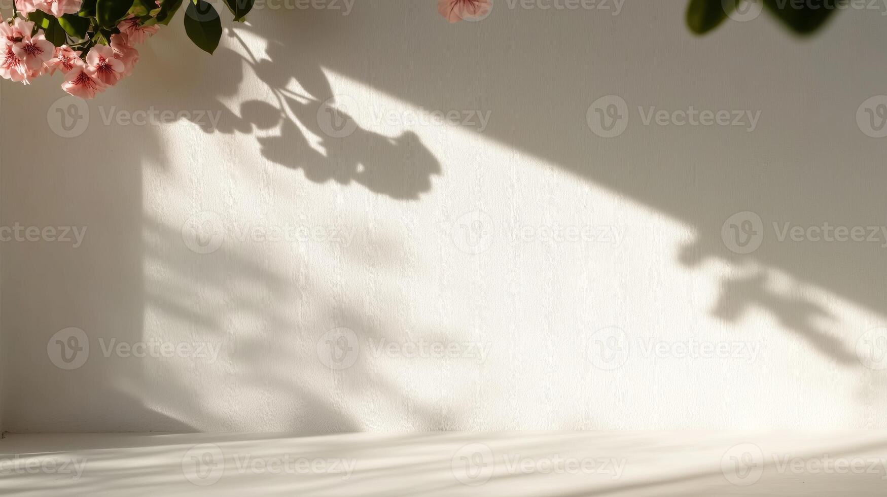 A white wall with pink flowers and shadows photo
