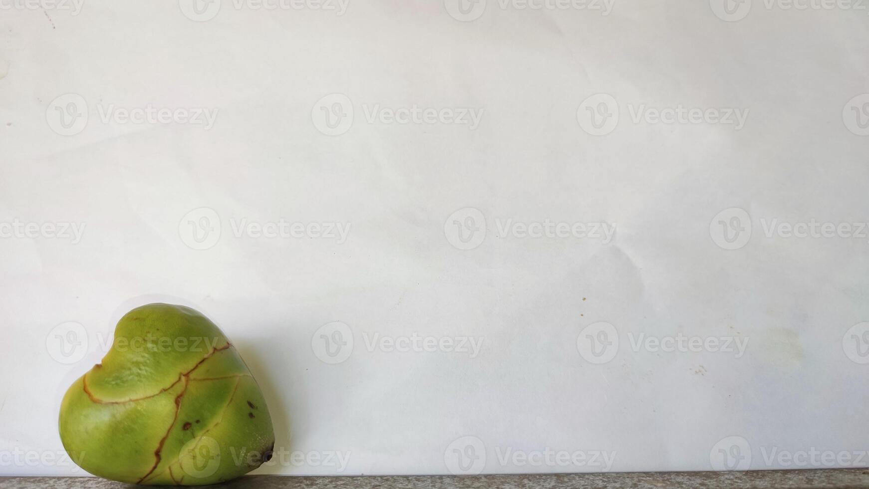A green coconut on a white background photo
