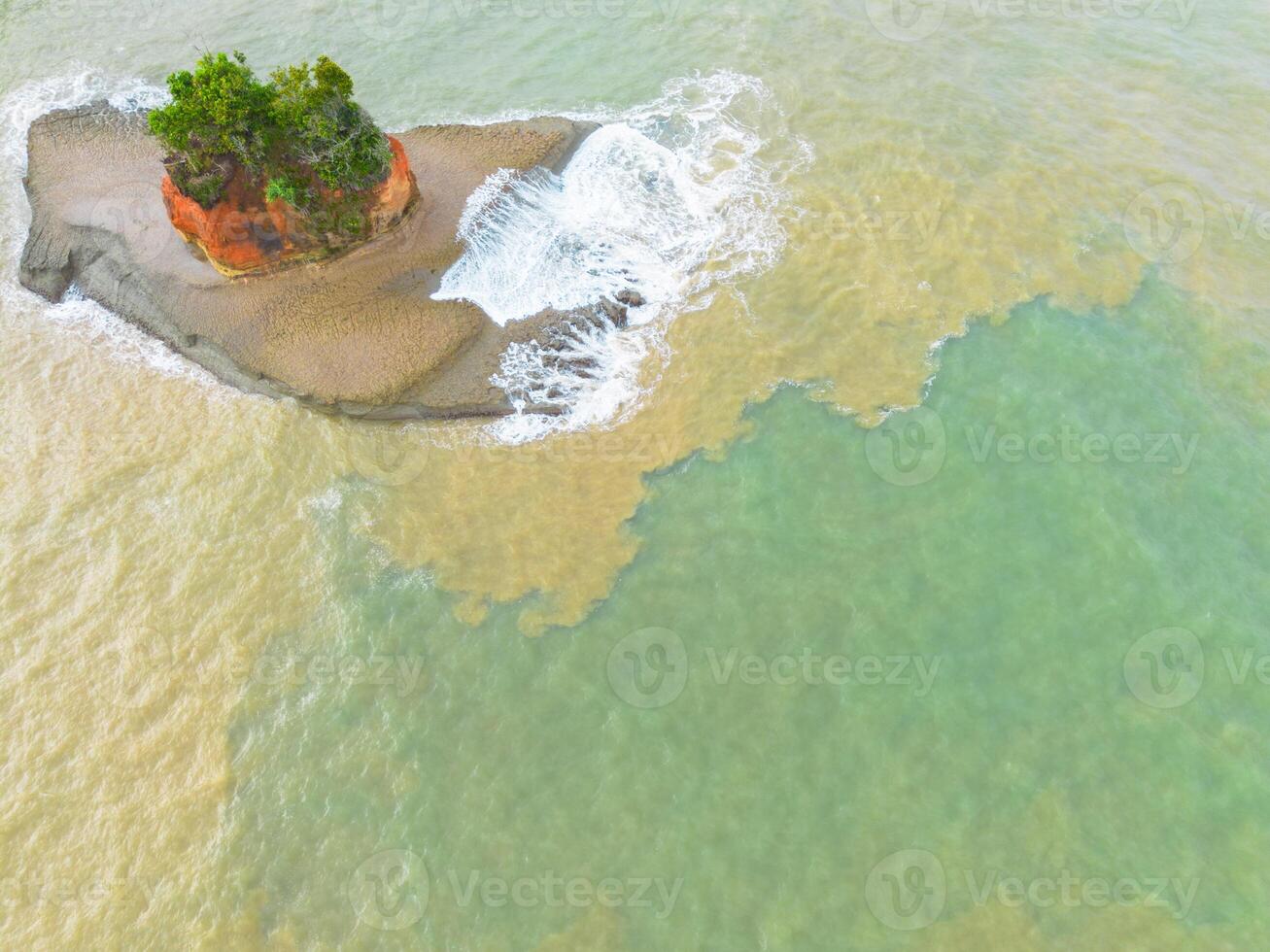 An aerial view of a small island in the ocean photo