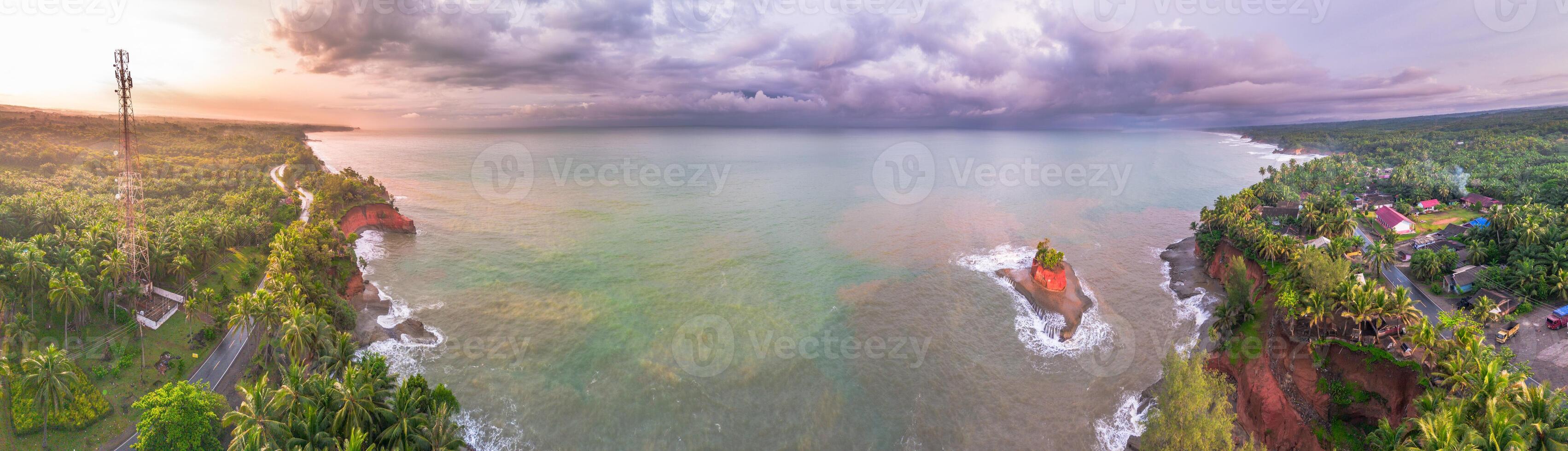 An aerial view of the ocean and a house photo