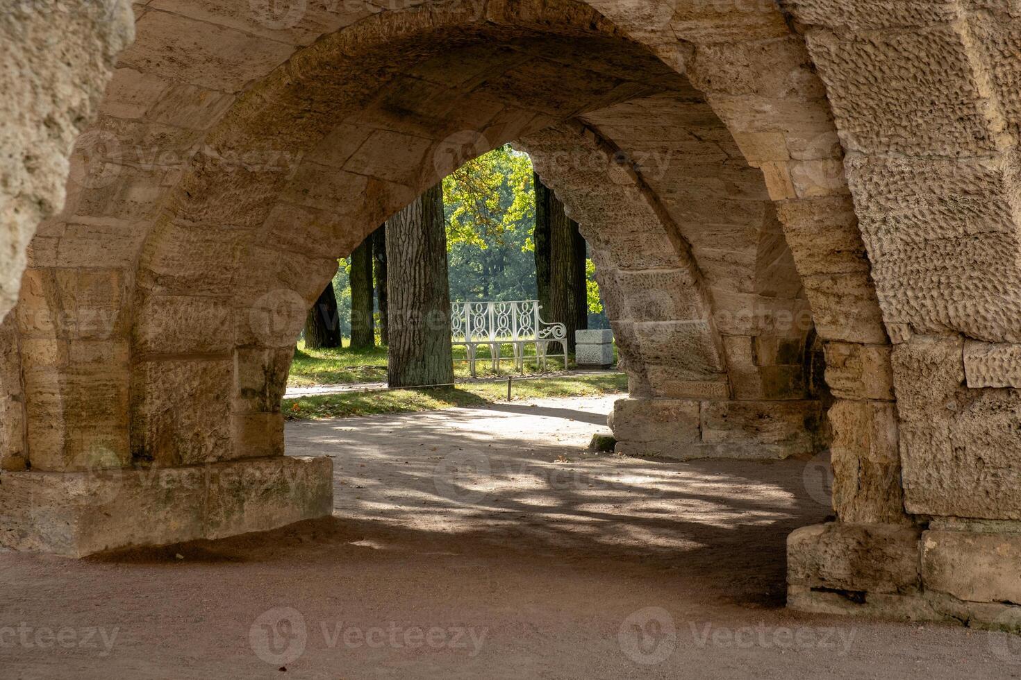 Exploring the tranquil pathways of the Great Catherine Palaces serene gardens and arches in late afternoon light photo