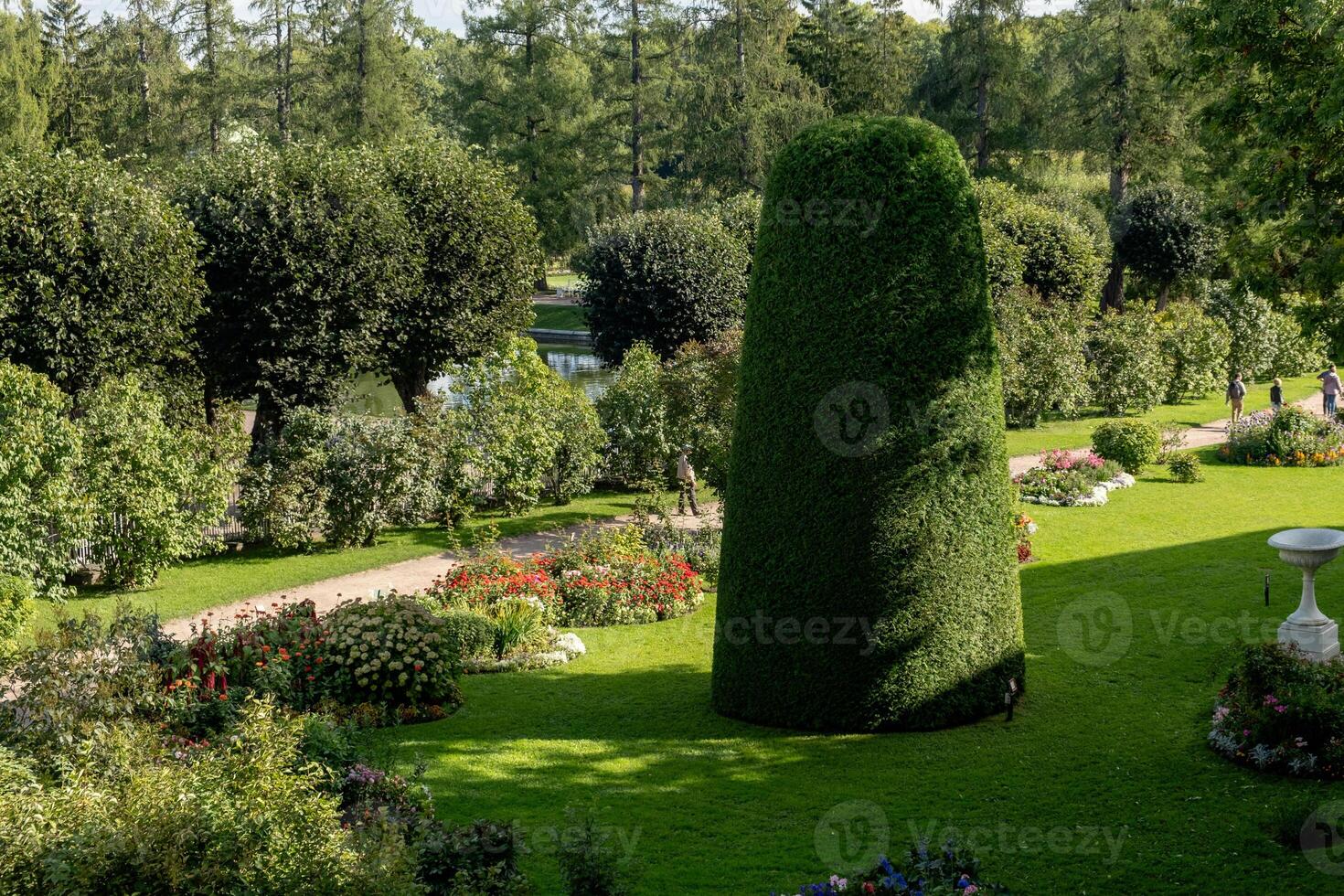 Exploring the beautifully manicured gardens of Catherine Palace in Tsarskoye Selo during a sunny summer afternoon photo