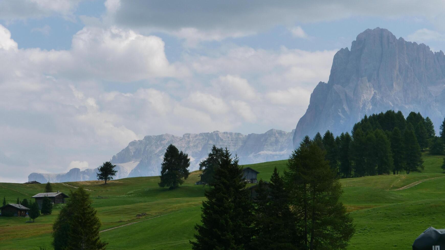 Majestic mountain landscape captures tranquility of alpine meadows and distant peaks under a dramatic sky photo