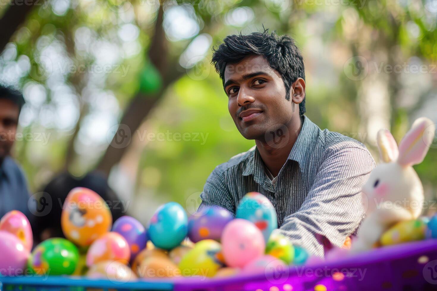 Young man enjoying Easter egg activity in park photo