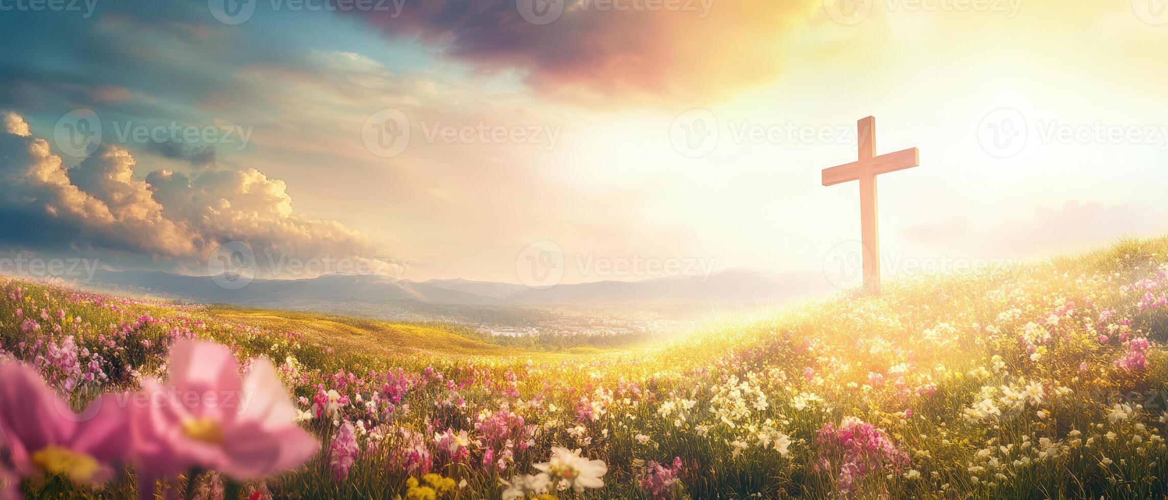 Sunrise over a flower filled meadow with a cross photo