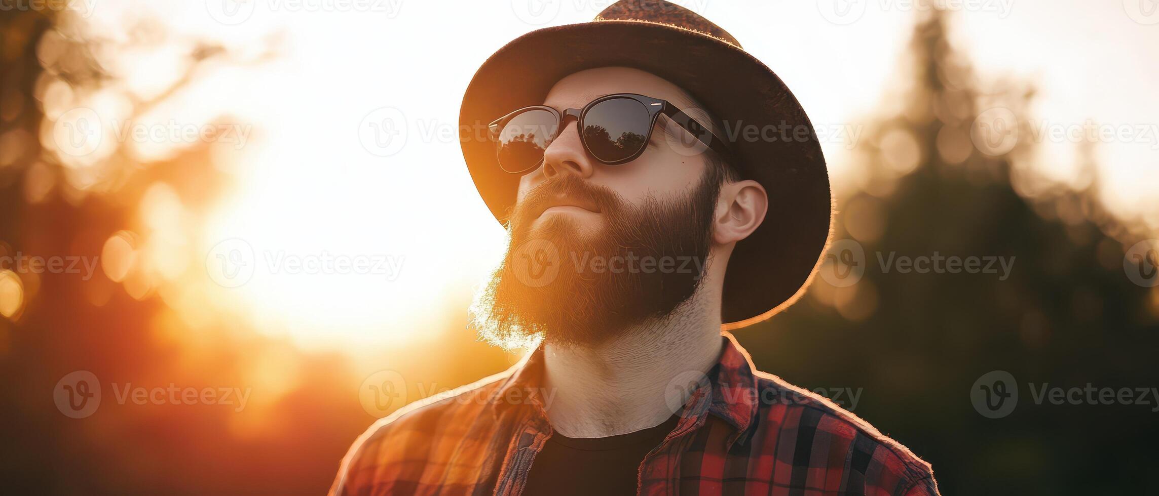 Man enjoying sunset outdoors with stylish attire photo