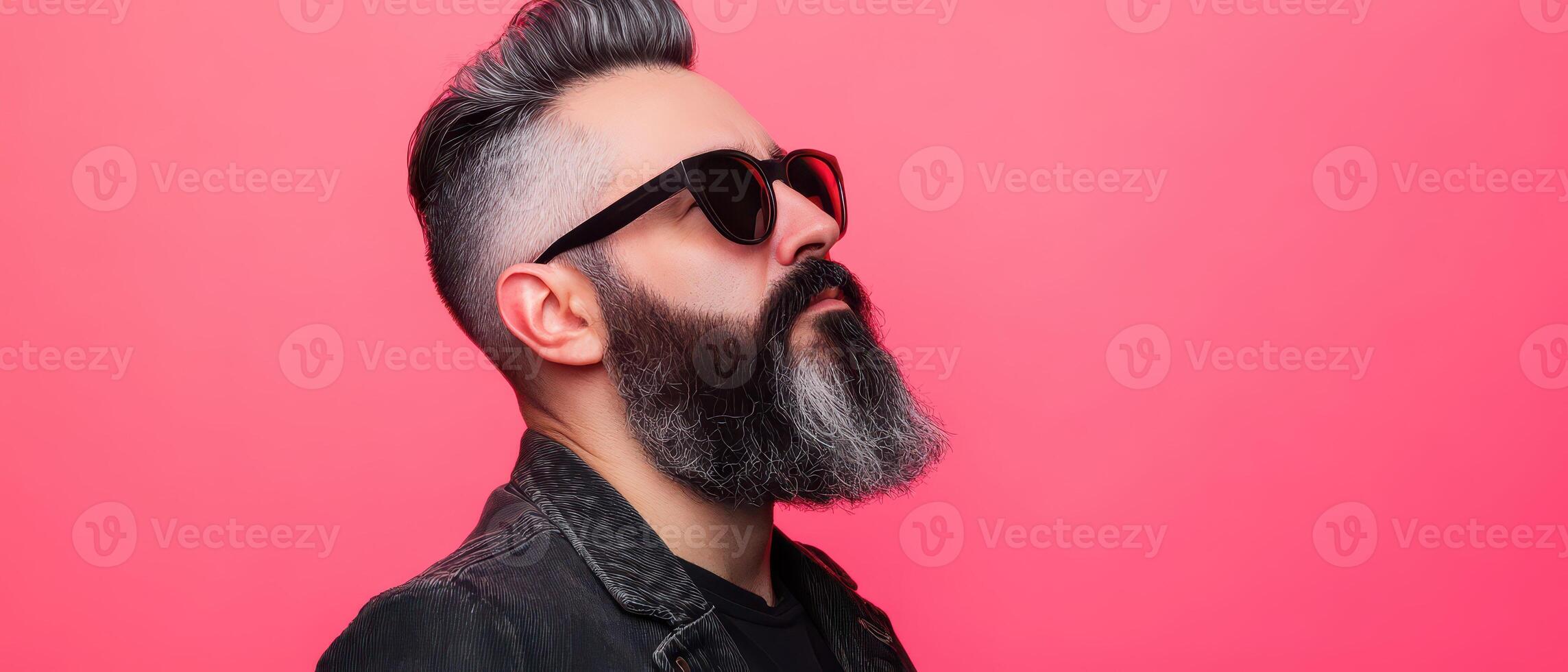 Bearded man in shades by pink background photo