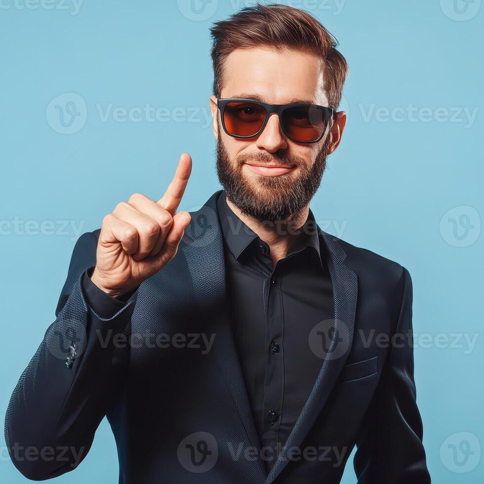 Stylish man in shades points confidently photo