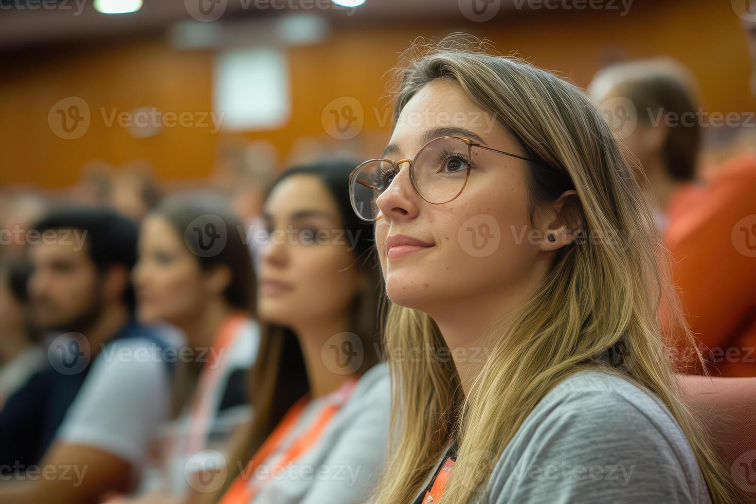 Attendees engaged in a seminar at an auditorium photo