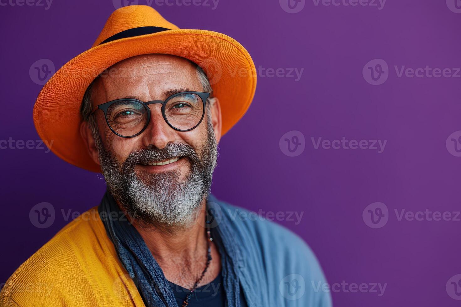 Smiling man with glasses wearing colorful hat photo