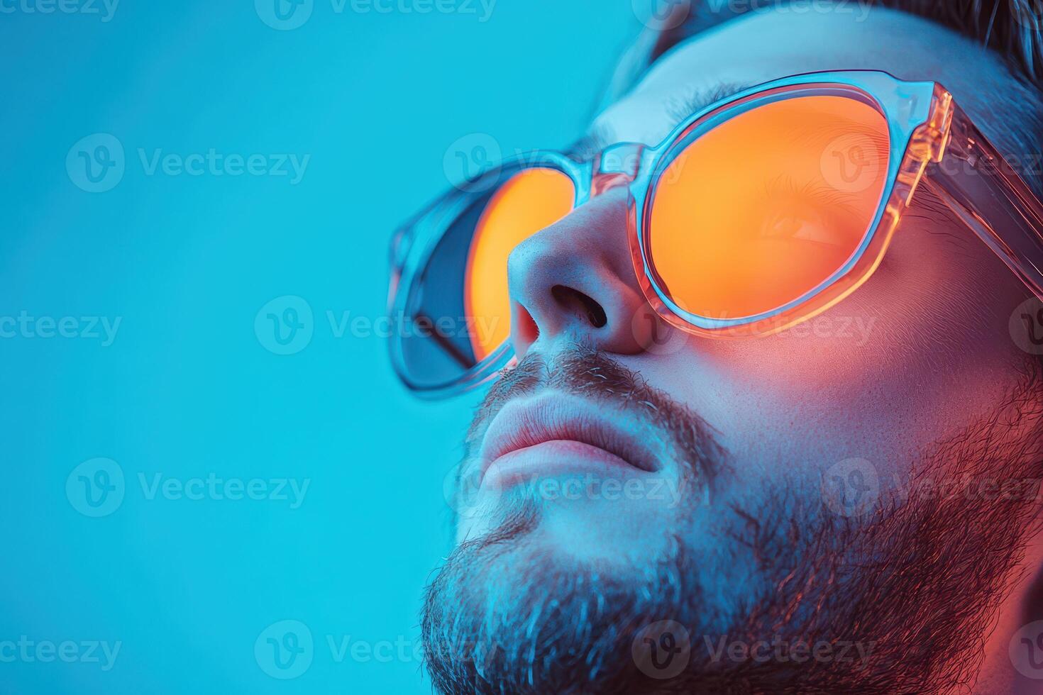 Man in shades against blue background photo